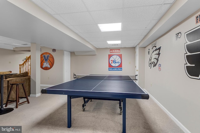 recreation room featuring carpet and a paneled ceiling