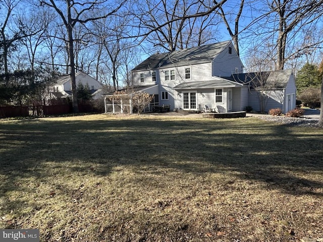 rear view of property with a lawn