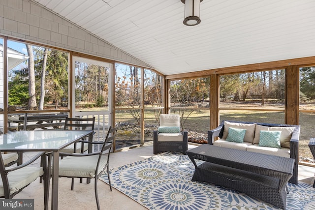 sunroom / solarium featuring vaulted ceiling