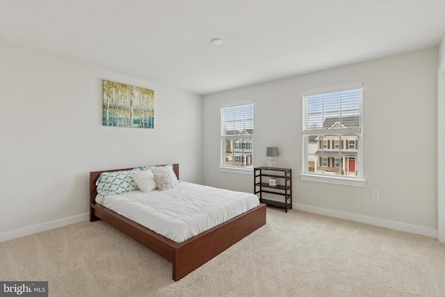 bedroom featuring baseboards and carpet floors