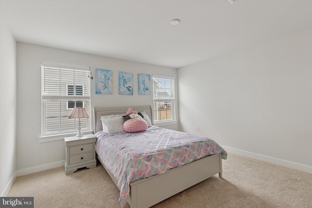 bedroom featuring baseboards and carpet