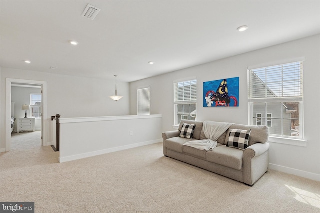 living room featuring light carpet, visible vents, recessed lighting, and baseboards