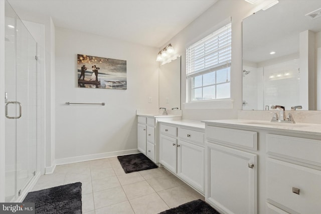 bathroom with visible vents, baseboards, a stall shower, tile patterned floors, and vanity