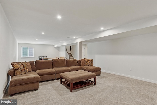 living area with recessed lighting, baseboards, light carpet, and stairs