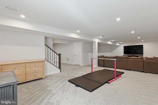 exercise area featuring recessed lighting, visible vents, baseboards, and light colored carpet