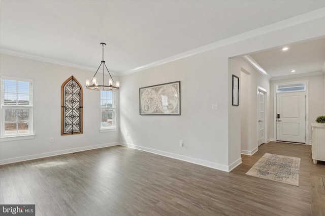 unfurnished dining area featuring baseboards, dark wood-type flooring, an inviting chandelier, and ornamental molding