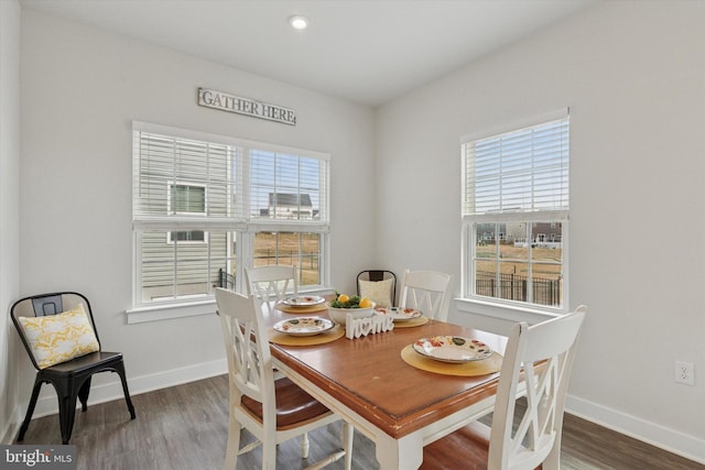 dining area with plenty of natural light and wood finished floors