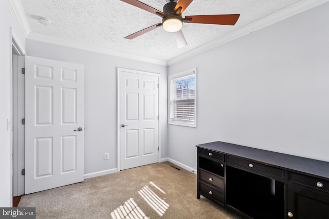 bedroom featuring ornamental molding, light colored carpet, a textured ceiling, and baseboards