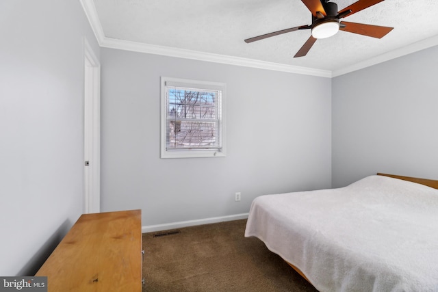 bedroom with baseboards, visible vents, carpet, a textured ceiling, and crown molding