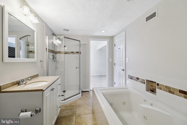 full bath featuring a shower stall, visible vents, a textured ceiling, and vanity