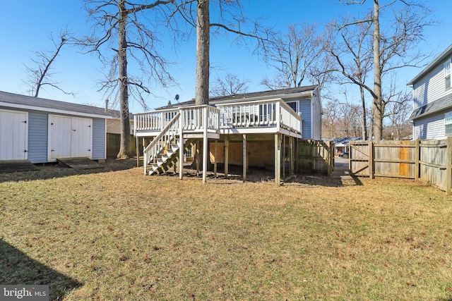 back of house with a yard, a fenced backyard, a deck, and an outdoor structure