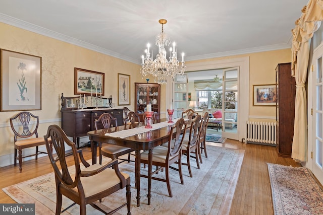 dining area with crown molding, radiator, and light wood-type flooring