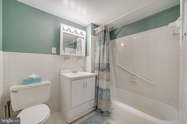 full bathroom with tile walls, vanity, toilet, shower / bath combo, and tile patterned floors