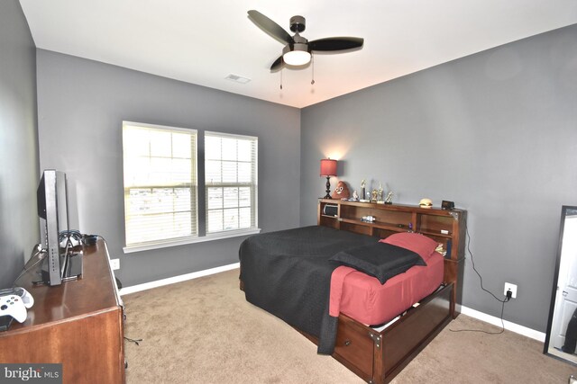 bedroom featuring ceiling fan and carpet