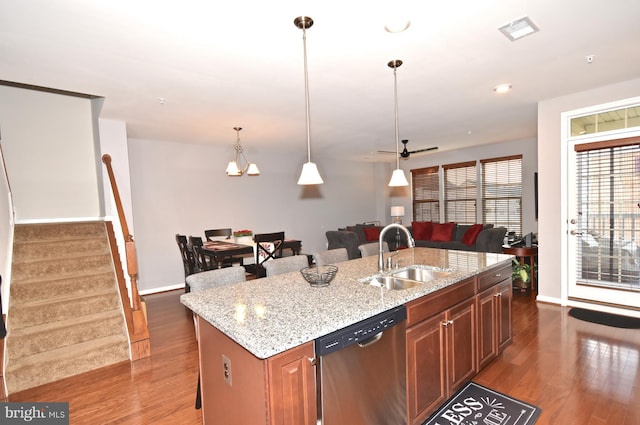 kitchen with sink, dark hardwood / wood-style flooring, a kitchen breakfast bar, a kitchen island with sink, and stainless steel dishwasher