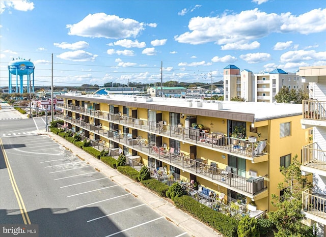 view of building exterior featuring uncovered parking