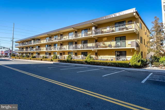 view of building exterior featuring uncovered parking