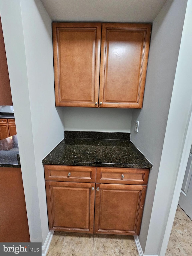 kitchen featuring dark stone countertops