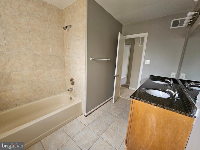 bathroom with tiled shower / bath, vanity, and tile patterned flooring