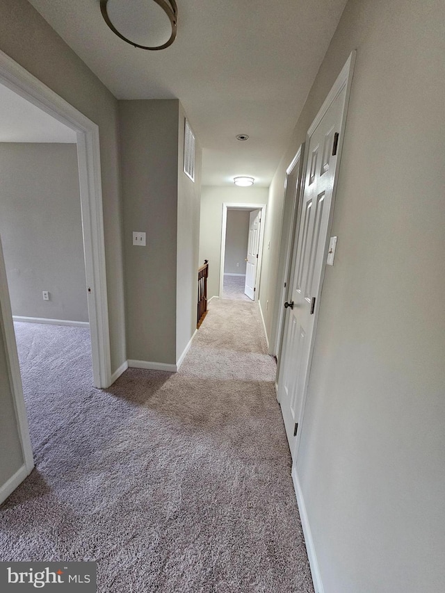 hallway featuring light carpet