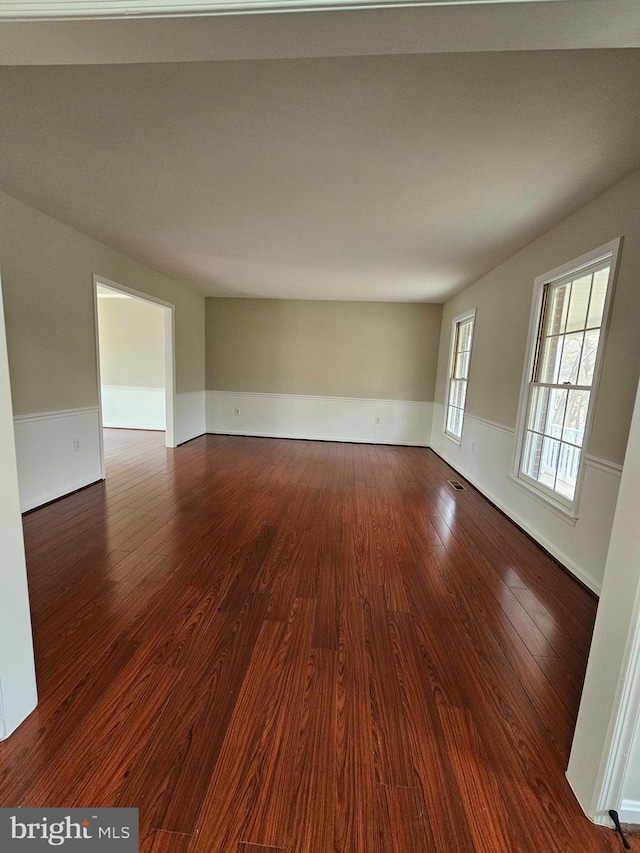 spare room with dark hardwood / wood-style flooring