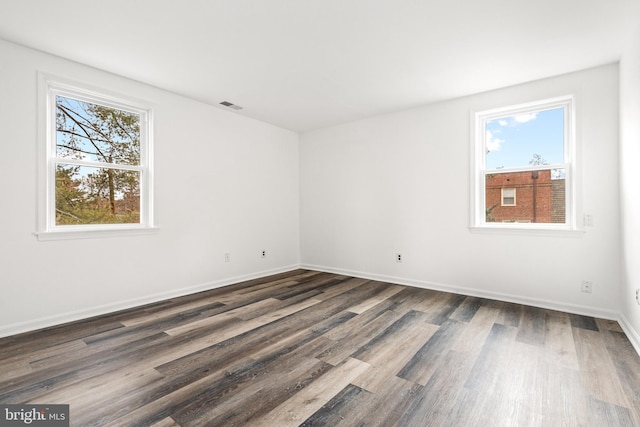 spare room featuring dark hardwood / wood-style floors