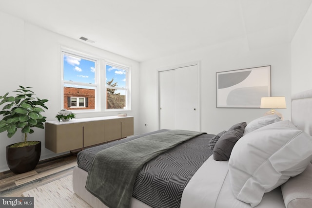 bedroom featuring light wood-type flooring and a closet