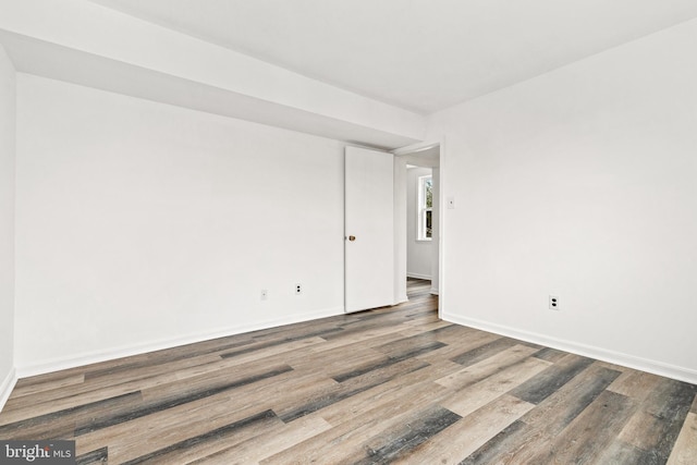 empty room with wood-type flooring