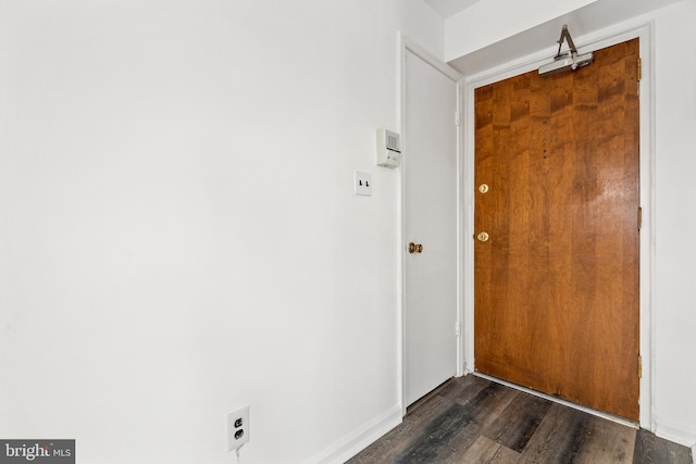 doorway with dark wood-type flooring