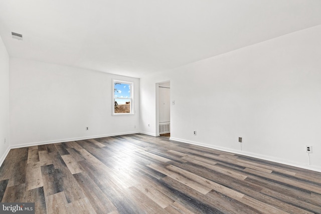 empty room featuring dark wood-type flooring