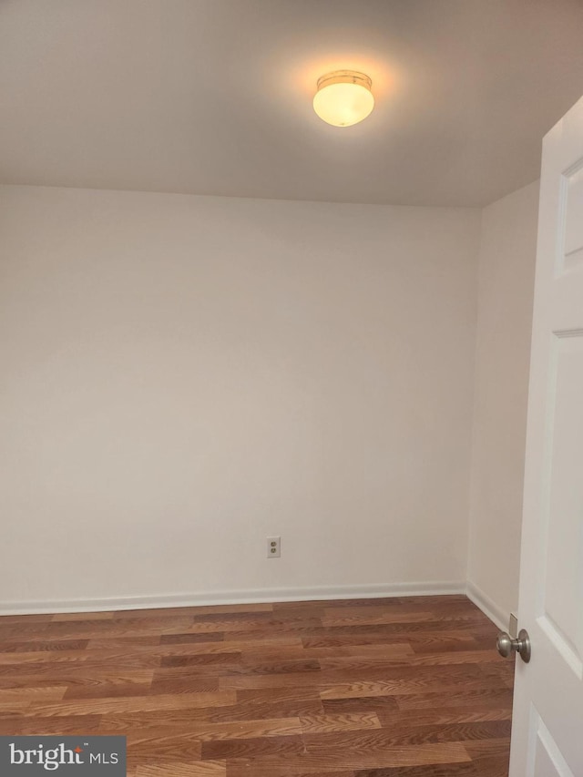 spare room with dark hardwood / wood-style floors