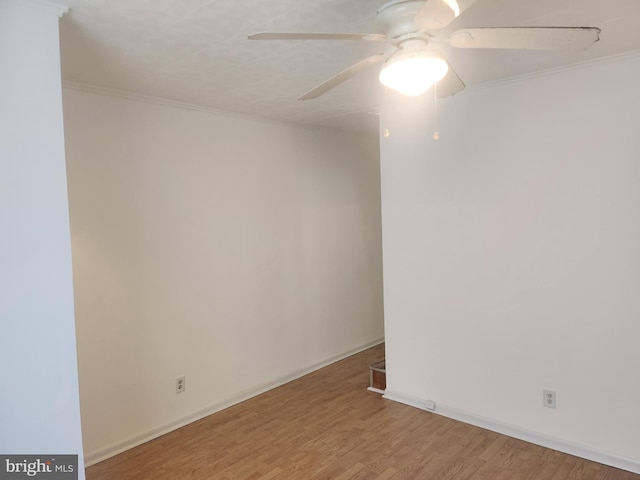 spare room featuring hardwood / wood-style flooring, ornamental molding, and ceiling fan