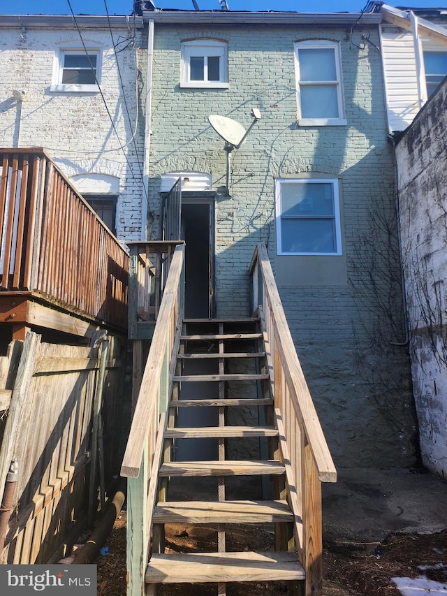 back of property with a wooden deck