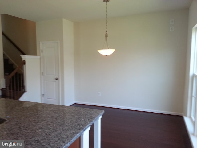 kitchen with dark wood-type flooring and hanging light fixtures