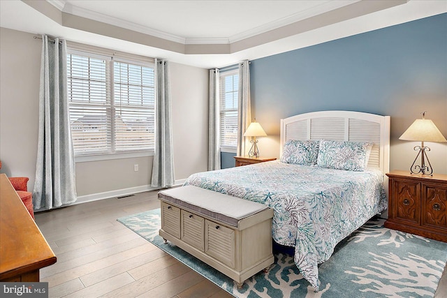 bedroom with crown molding and light wood-type flooring