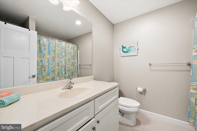 bathroom with tile patterned flooring, vanity, and toilet