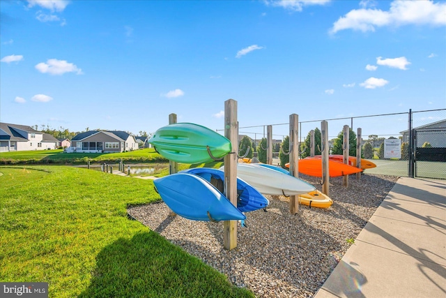 view of play area with a water view and a yard