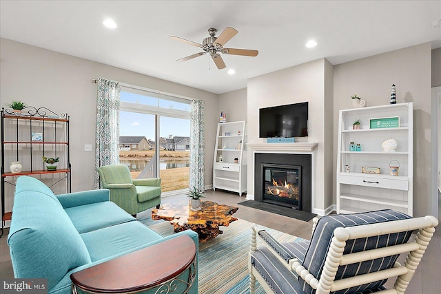 living room with wood-type flooring and ceiling fan