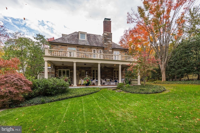 back of house with a balcony, a yard, ceiling fan, and a patio area