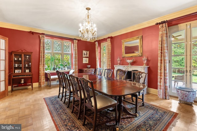 dining space with ornamental molding, french doors, a chandelier, and baseboards