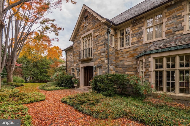 view of side of property with stone siding