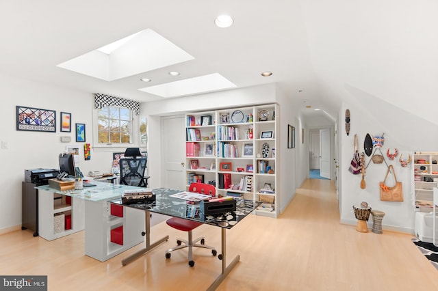 office featuring a skylight, baseboards, wood finished floors, and recessed lighting