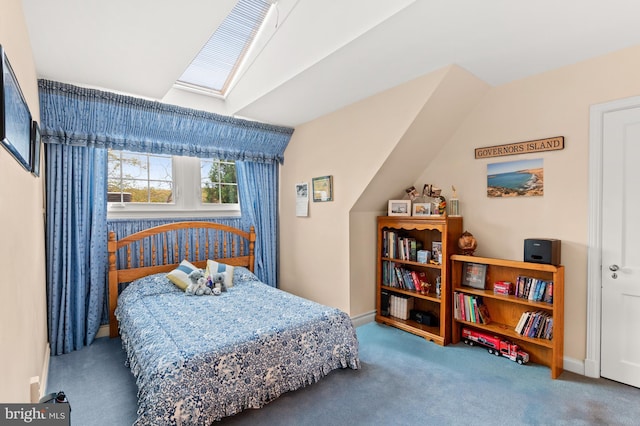 carpeted bedroom with a skylight and baseboards