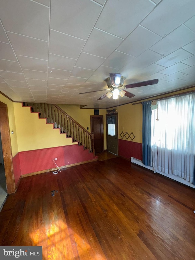 unfurnished living room featuring dark hardwood / wood-style floors and ceiling fan