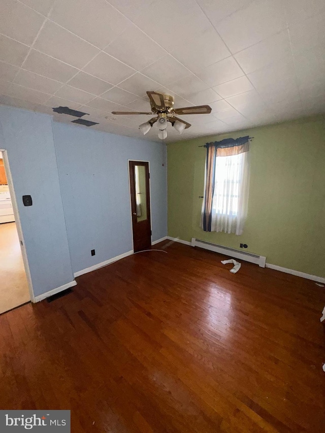 unfurnished room featuring hardwood / wood-style floors, ceiling fan, and baseboard heating