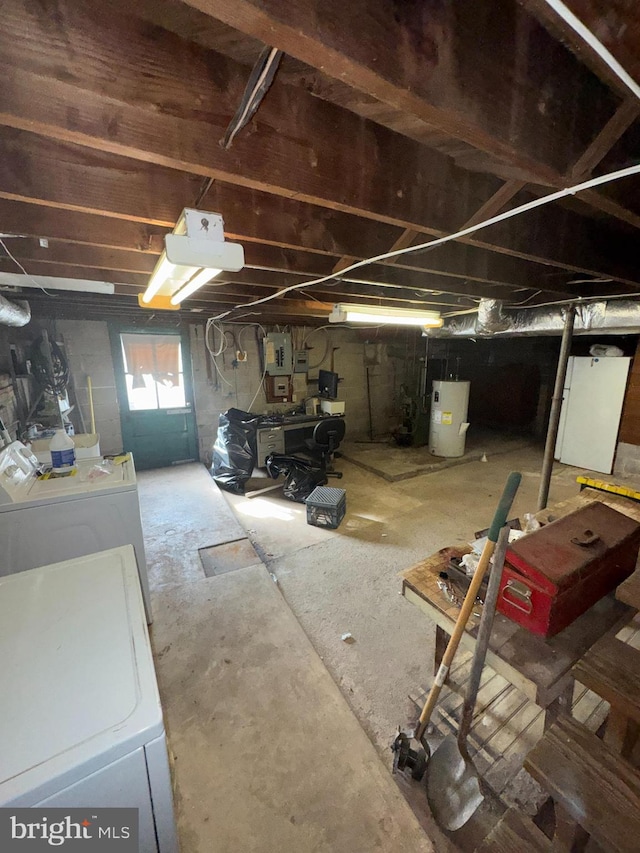 basement with washer and dryer, electric water heater, and electric panel