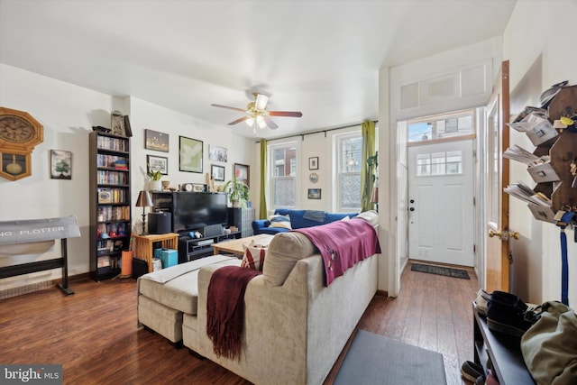 living room featuring ceiling fan and dark hardwood / wood-style floors