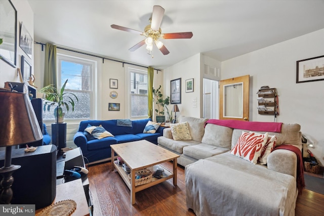 living room with dark wood-type flooring and ceiling fan