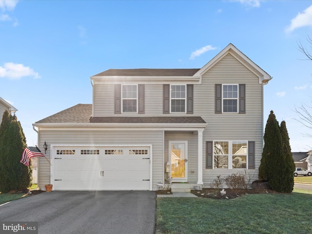 view of front property with a garage and a front lawn