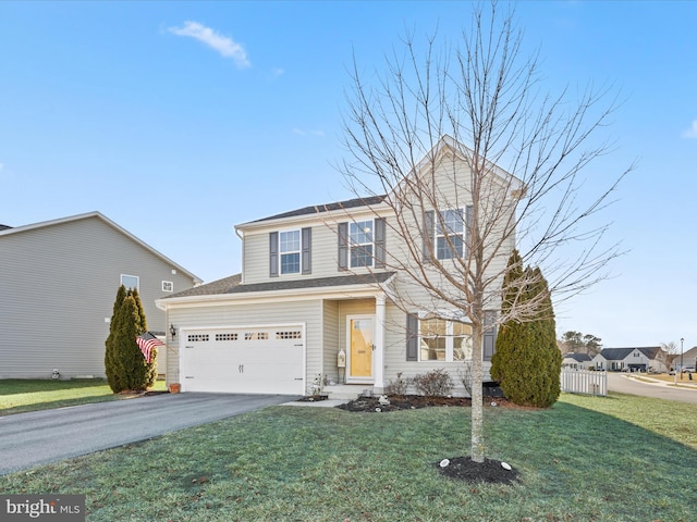 view of property with a garage and a front lawn